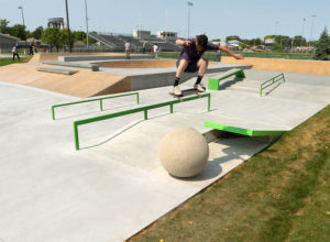 Ollie over the ball at the street course Norfolk Skatepark