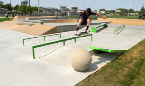 Ollie over the ball at the street course Norfolk Skatepark