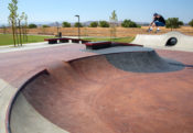 Jake Wooten whoops over the hip at Perris Skatepark