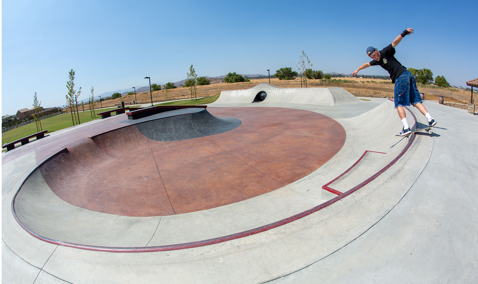 Backside Lip by Jake Wooten around the bowl of Perris Skatepark