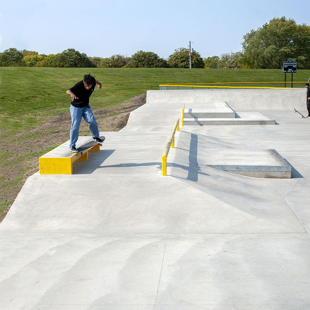 Crooked Grind at Waterloo Skatepark Iowa on the ledge dropping into a bank