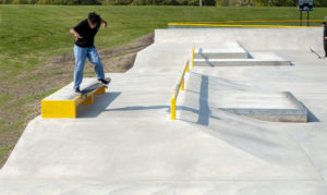 Crooked Grind at Waterloo Skatepark Iowa on the ledge dropping into a bank