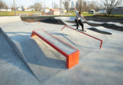 Feeble grind down the orange handrail at the skatepark located in Gibson City, IL