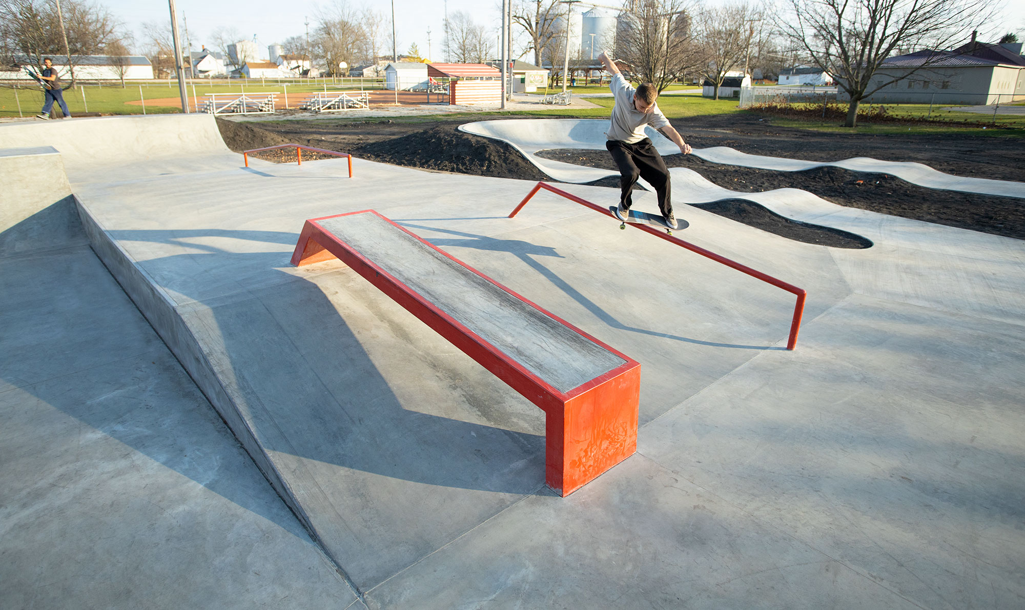 Feeble grind down the orange handrail at the skatepark located in Gibson City, IL