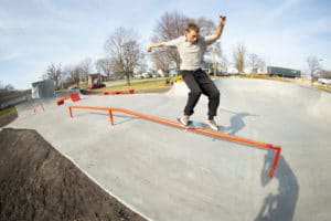 Designed and Built by Spohn Ranch showcases a feeble skateboard trick in Gibson City