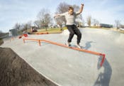 Feeble grind down the orange handrail at the skatepark located in Gibson City, IL