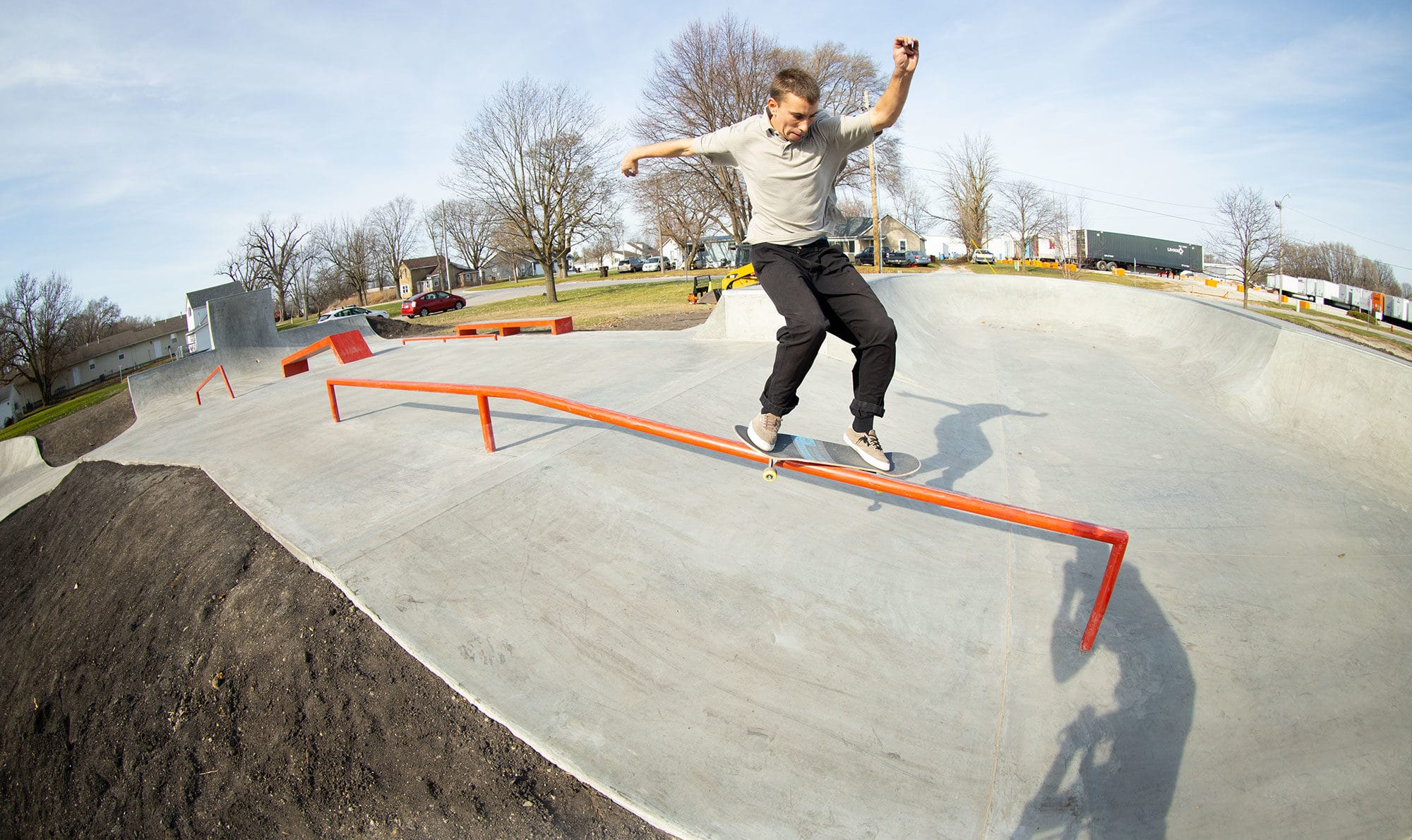 Feeble grind down the orange handrail at the skatepark located in Gibson City, IL