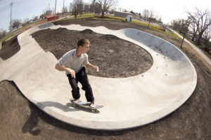 frontside carve in the pump track at Ed Day Memorial Skatepark in Gibson City, IL