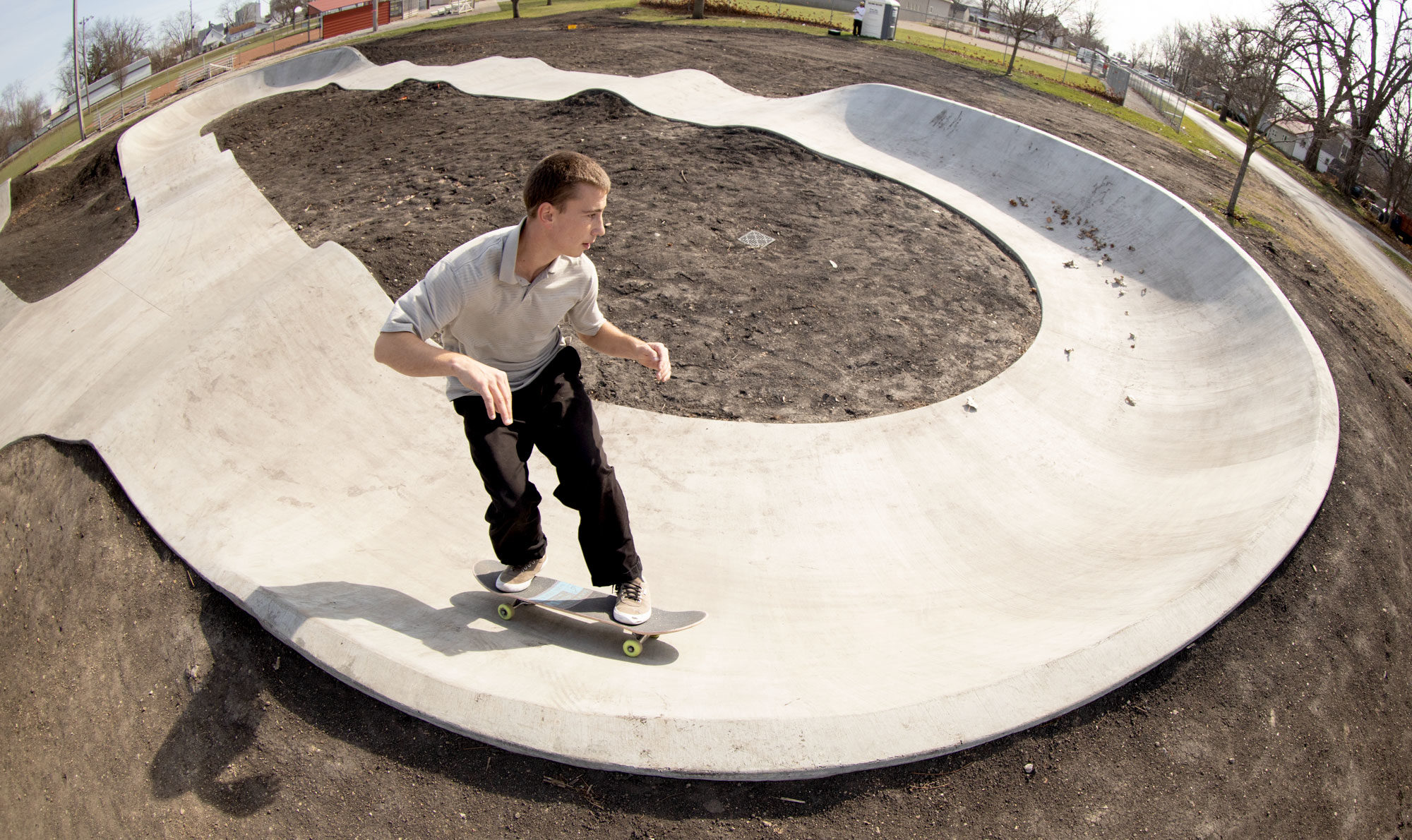 frontside carve in the pump track at Ed Day Memorial Skatepark in Gibson City, IL