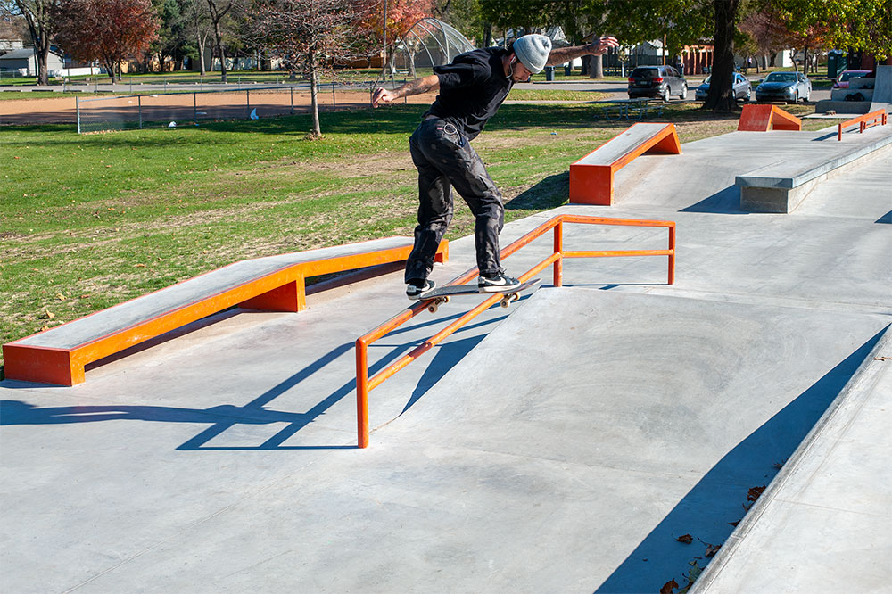 Backside tail on the A-Frame rail at West Des Moines Iowa Skatepark by Spohn Ranch