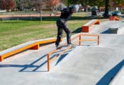 Backside tail on the A-Frame rail at West Des Moines Iowa Skatepark by Spohn Ranch