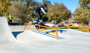 West Des Moines resident performs a Crooked Grind down the grind rail at the skatepark design and built by Spohn Ranch