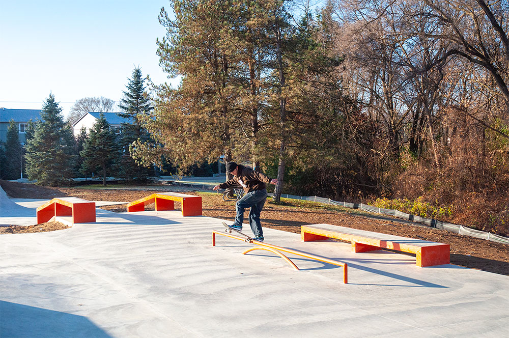 A frontside blunt side at a skatepark filled with Rails, Hubbas, Ledges, Transition, Volcano and tons of shade