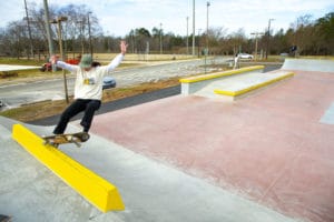Shredding a frontside 5.0 on the curb on the top of the deck at Mecklenburg Skatepark in North Carolina