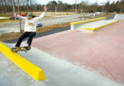 Shredding a frontside 5.0 on the curb on the top of the deck at Mecklenburg Skatepark in North Carolina