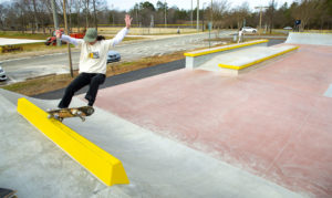 Shredding a frontside 5.0 on the curb on the top of the deck at Mecklenburg Skatepark in North Carolina