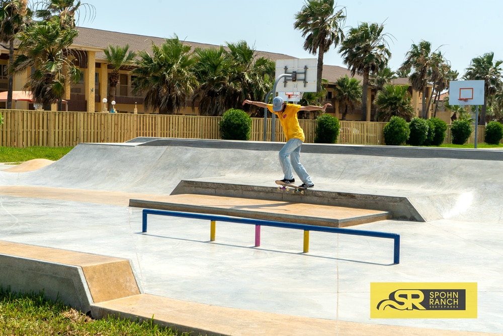 Backside tail across the manny pad by Mikey Whitehouse at South Padre Island Skatepark in Texas