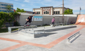 Tyson Bowerbank kickfliping the kicker over bar