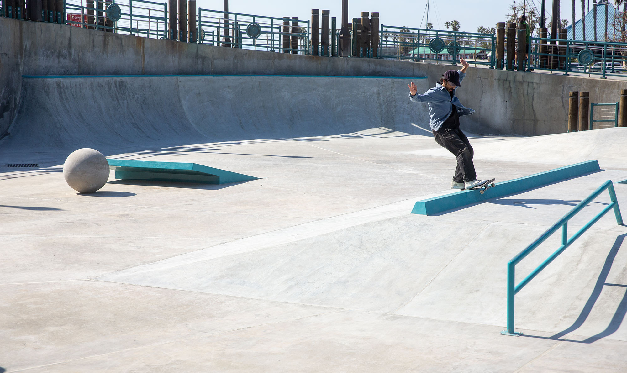 Chocolate Skateboards professional Kenny Anderson frontside feeble at the Redondo Beach Pier Skatepark slappy curb. Designed and built by Spohn Ranch